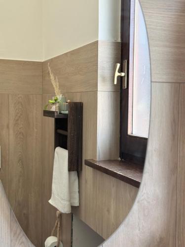 a bathroom with a mirror and a sink and a window at Cà di Grè - Camigliatello Silano in Camigliatello Silano
