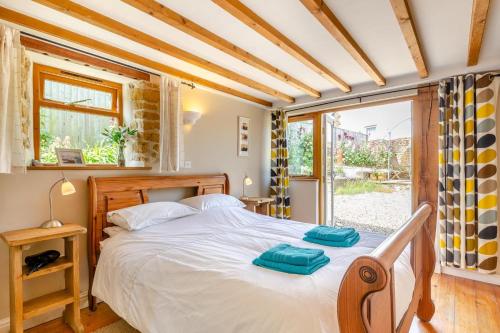 a bedroom with a bed with two towels on it at 2 Bed in Bridport oc-dc111 in Chideock