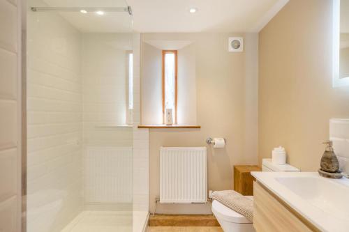 a bathroom with a shower and a toilet and a sink at 2 Bed in Bridport oc-dc111 in Chideock