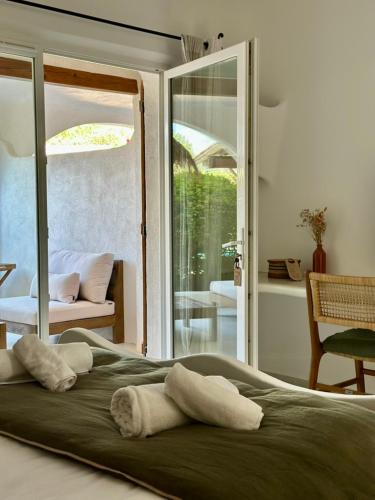 a bed with two pillows on top of it at Hôtel Palombaggia in Porto-Vecchio