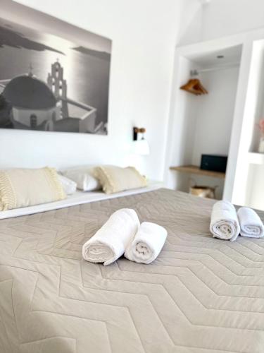 a group of towels sitting on top of a bed at Giasemi Fira Studios in Fira