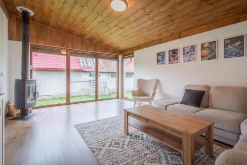 a living room with a couch and a wooden ceiling at Modrý Dom - Telgárt Resort in Telgárt