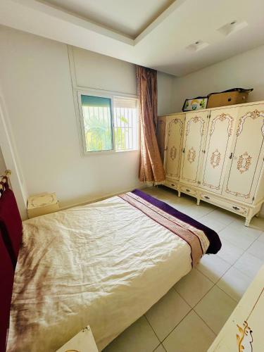 a bedroom with a bed and a window at Waterfront house 1 in Kelibia