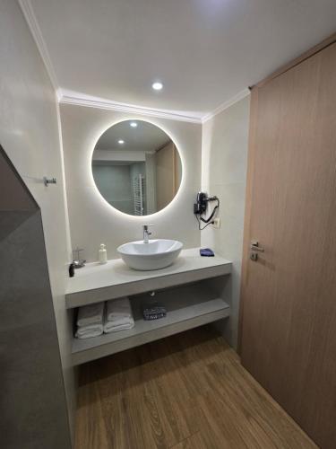 a bathroom with a sink and a mirror at Pension Alexandra in Parga