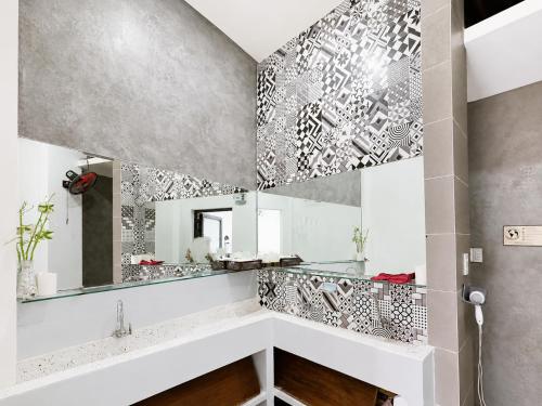 a bathroom with a mirror and a sink at Lacasa Homestay in Hue