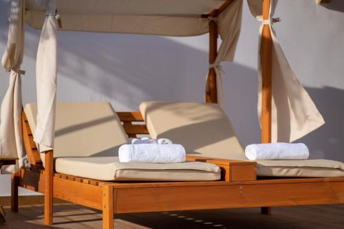 a bunk bed with two beds with towels at Galini Hellenic Hospitality in Patitiri