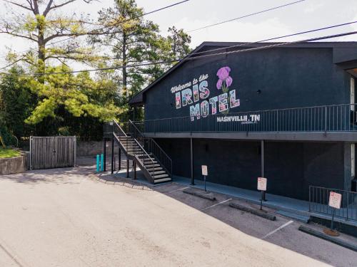 a building with a sign on the side of it at The Iris Motel in Nashville