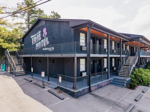 a black building with stairs on the side of it at The Iris Motel in Nashville