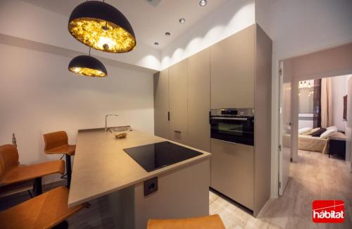 a kitchen with a counter top and a stove top oven at Domus Halo D in Pamplona