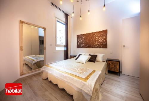 a bedroom with a large bed and a mirror at Domus Halo D in Pamplona