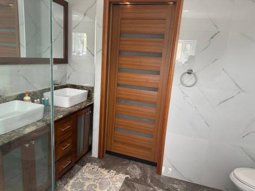 a bathroom with a toilet and a sink and a shower at Elegant 3-Bedroom Loft Condo in Kingston