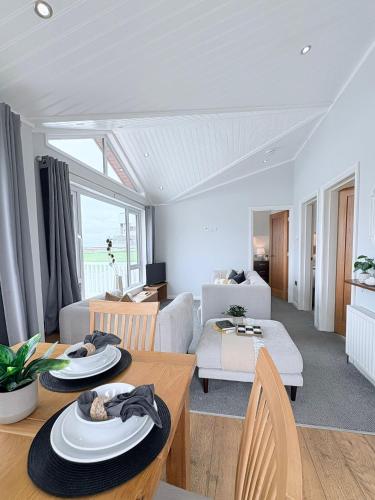 a living room with a couch and a table at Sea View Retreat Lodge in Heysham