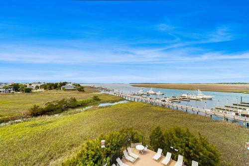 an aerial view of a marina with white chairs and a dock at Bay Creek Villa - 311 in Edisto Beach