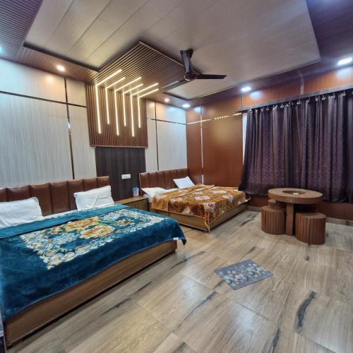 a bedroom with two beds and a table and chairs at Inder's Heritage in Bangīna