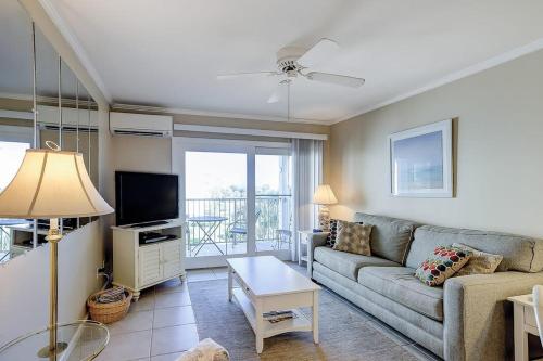 a living room with a couch and a tv at Beachwood Place 3E in Hilton Head Island