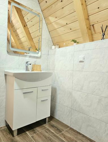 a bathroom with a white sink and a mirror at Vikendice Una i Andrea in Bileća