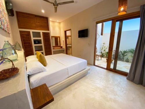 a bedroom with a bed and a view of the ocean at MAJO Hotel Boutique in Holbox Island