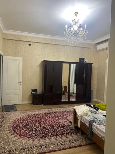 a room with a bed and a chandelier at Luxury Tashkent house Zenith in Tashkent