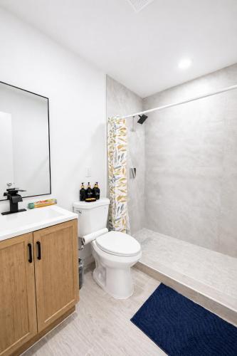 a bathroom with a toilet and a sink and a shower at 05 Modern Co-Living Home with Newly Renovated Private Rooms Available in Miami