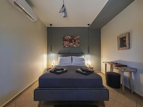 a bedroom with a bed and a desk in it at Casa Katrine in Lakíthra