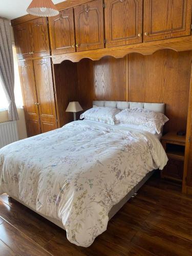 a bedroom with a bed with a wooden head board at Athenry Stay in Athenry