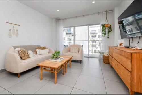 a living room with two couches and a coffee table at Harbour House apt 410 in Oranjestad