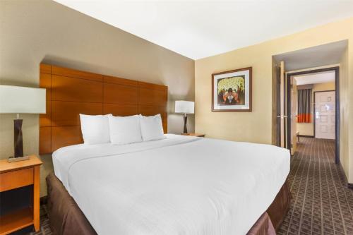 a large white bed in a hotel room at Best Western Plus Scottsdale Thunderbird Suites in Scottsdale