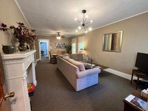 a living room with a couch and a fireplace at Great Gorge Guesthouse - Walk to the Falls, the Casino and all Downtown Restaurants - Across from the Aquarium in Niagara Falls