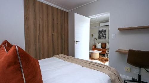 a bedroom with a bed and a chair in a room at Ballito Hill's Serenity Suite in Ballito
