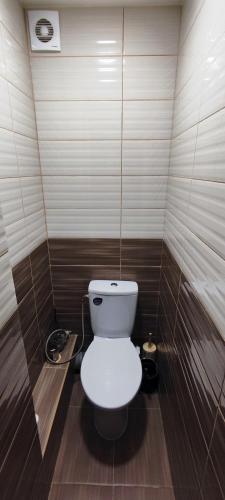 a bathroom with a white toilet in a room at Homestay Ezerkrasts in Liepāja