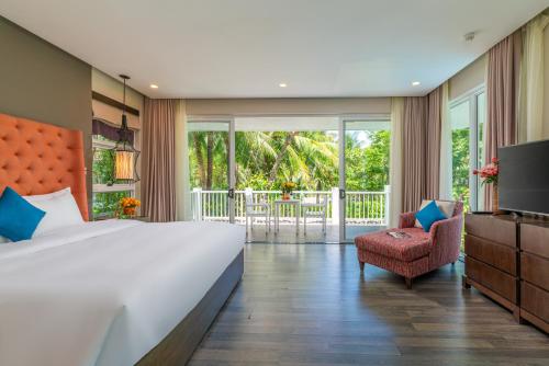 a bedroom with a large bed and a balcony at Diamond sea villa in Danang