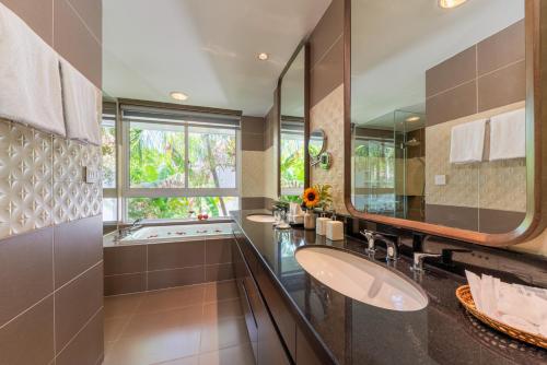 a bathroom with two sinks and a large mirror at Diamond sea villa in Danang