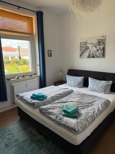 a bedroom with a bed with two towels on it at Crampas 1 in Sassnitz