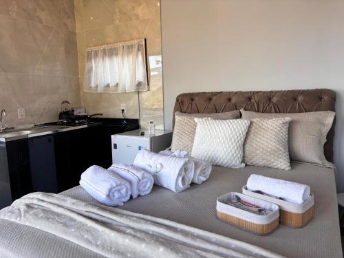 a bedroom with a bed with towels on it at Sítio Volta Fria in Pedra Menina