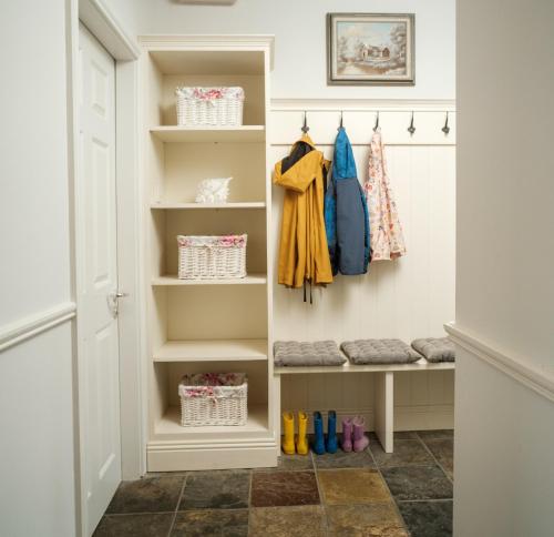 a walk in closet with shelves and shoes at Apartment 1 in Doolin