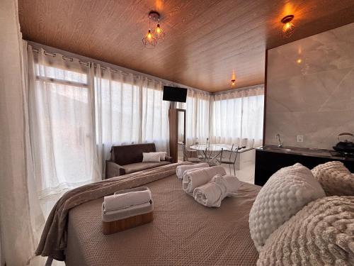 a bedroom with a large bed with white pillows on it at Sítio Volta Fria in Pedra Menina