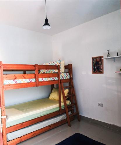 a bedroom with two bunk beds in a room at Casa dos bons encontros in Santa Isabel