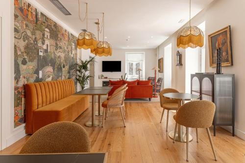 a living room with a couch and a table and chairs at Chalet Santo António in Sintra