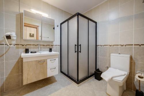 a bathroom with a toilet and a sink at Lagoonia Sun Hotel in Fethiye
