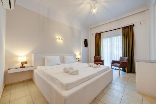 a bedroom with a large white bed in a room at Lagoonia Sun Hotel in Fethiye