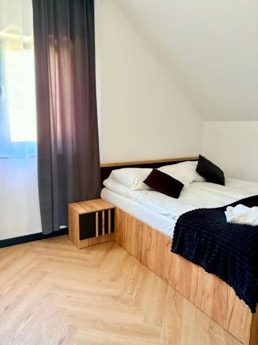 a bedroom with two twin beds and a window at Domek Veron 2 in Hańczowa