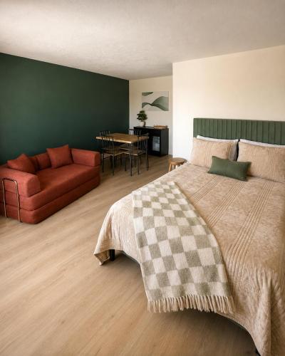 a bedroom with a bed and a couch and a table at Kiva Motel in Show Low