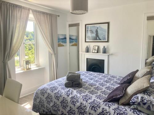 a bedroom with a bed with a teddy bear on it at Sommersway Cottage in Torquay