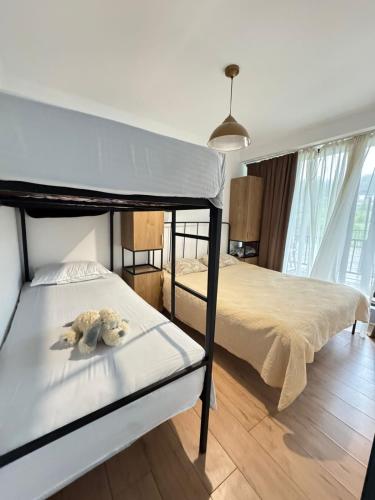 a bedroom with two bunk beds and a teddy bear at Bakuriani Panorama in Bakuriani