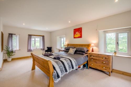 a bedroom with a bed and a dresser and windows at 7 Bed in Langbar oc-d34075 in Middleton