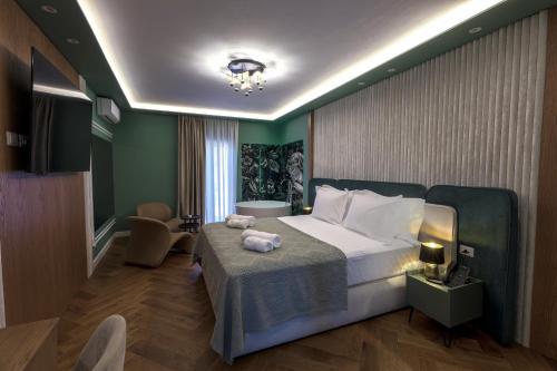 a bedroom with a bed in a room with green walls at Voko by Uka Boutique Hotel in Tirana