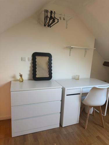 a white desk with a chair and a mirror at Rose CosyHome Paris Champs in Champs-sur-Marne