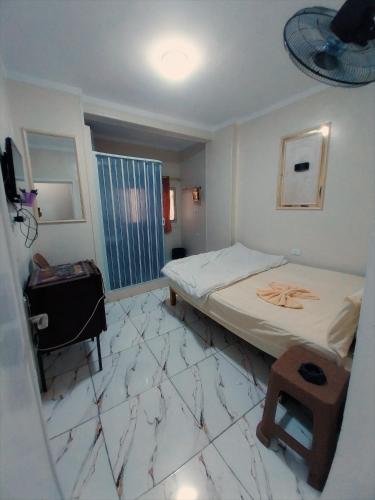a room with two beds and a table in it at El Temsah Hotel in Cairo