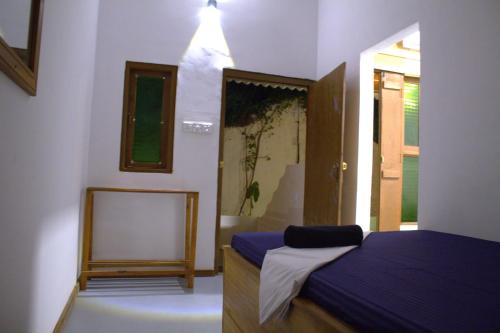 a bedroom with a bed and a mirror in it at Arugambay Wave House in Arugam Bay