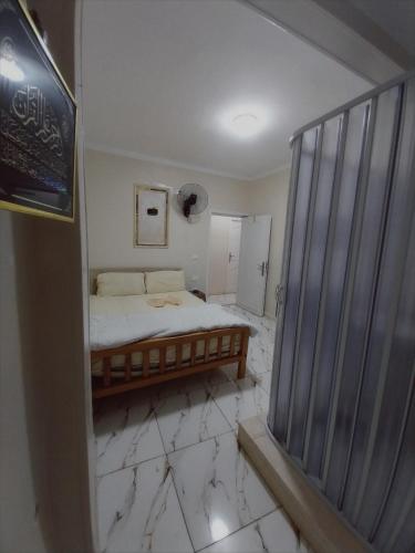 a bedroom with a bed on a marble floor at El Temsah Hotel in Cairo
